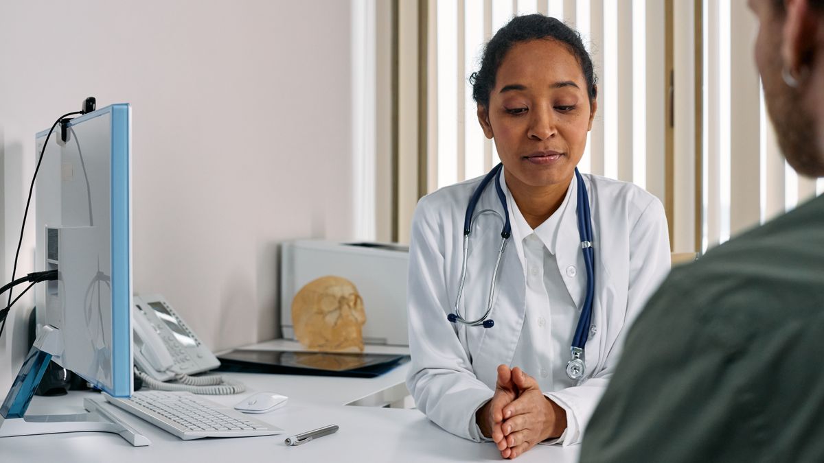 Female doctor consulting a woman patient in a clinic about a breast health concern