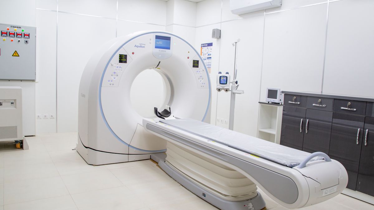 Cross-sectional scanner in a hospital imaging suite used for spinal assessment when detailed imaging is required
